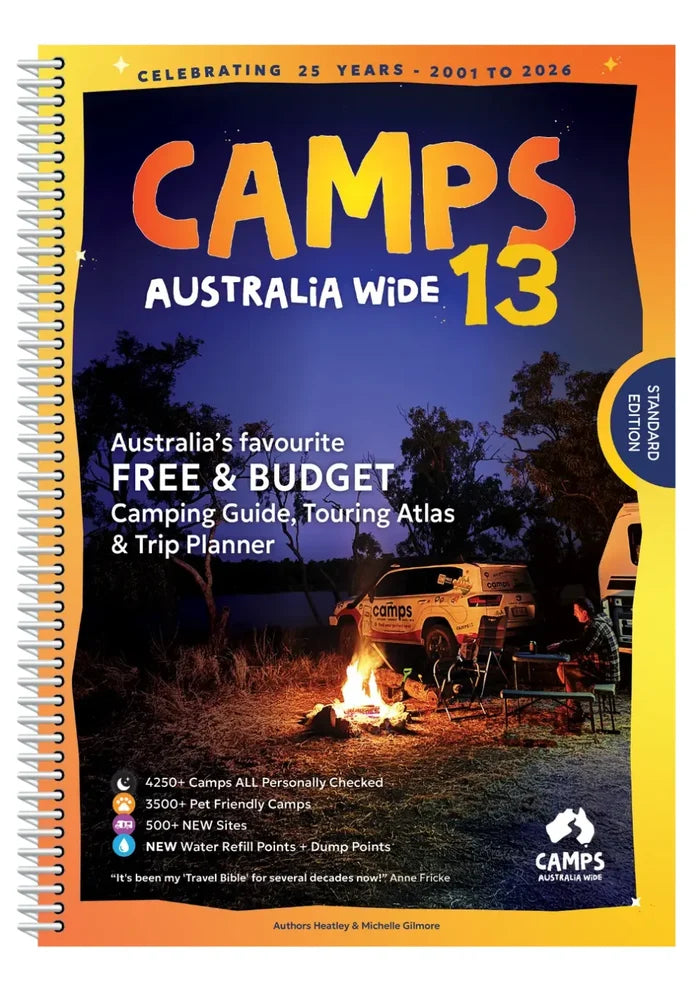 A spiral-bound camps australia wide 13 guidebook with an orange and yellow cover showing a night campsite scene
