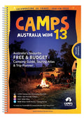 A spiral-bound camps australia wide 13 guidebook with an orange and yellow cover showing a night campsite scene