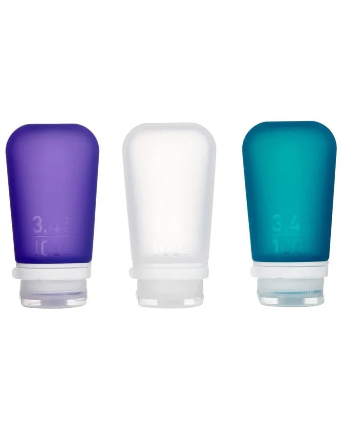 Three soft travel bottles in purple clear and teal silicone goToob plus 100 ml travel squeeze bottles large pack
