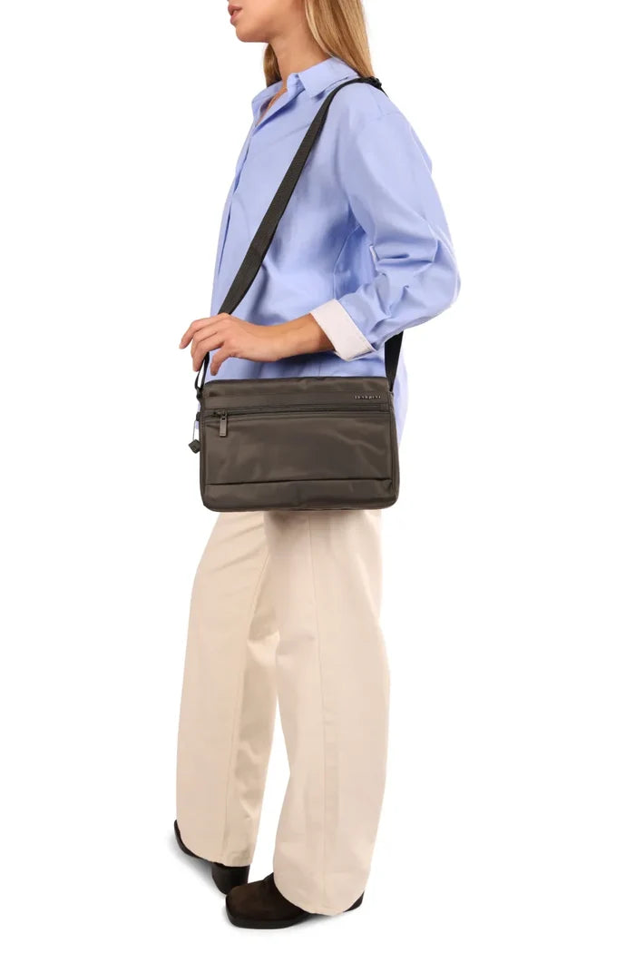 Hedgren ORVA Crossbody Bag with RFID Pocket in Black Gradient Print, worn crossbody at the waist by a woman in a blue shirt, seen from the side