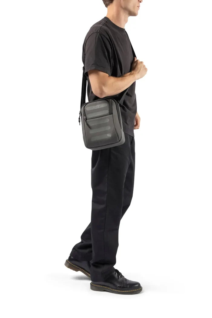Hedgren RELAX Medium Vertical Crossbody Bag with RFID Pocket in Black, worn crossbody by a man in a dark tee, seen from the side