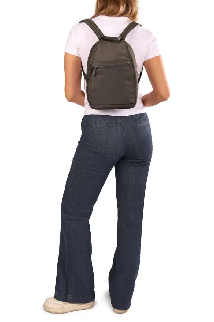 Hedgren VOGUE Small Backpack in Quilted Black, worn on both shoulders by a woman in a pale tee and jeans, seen from behind
