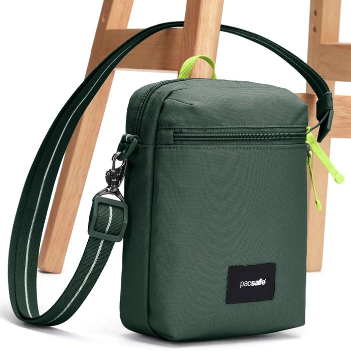 Green pacsafe festival crossbody bag with black strap and dock lock logo patch perfect for secure daily use