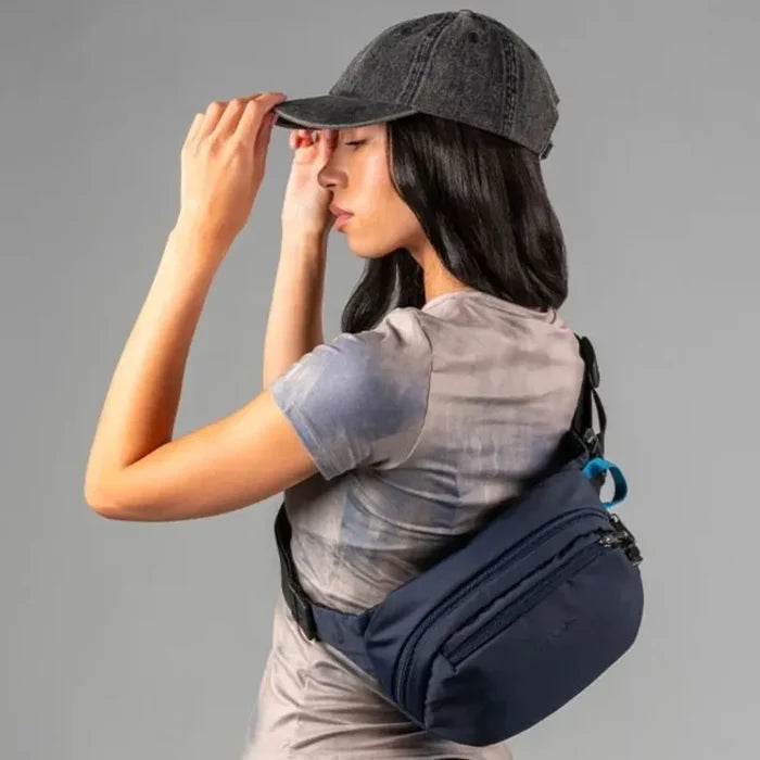 Girl with a Pacsafe V Anti-Theft Hip Pack Ocean colour around her torso