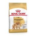 A bag of Royal Canin Pomeranian adult dog food, featuring a white and gold package design with a picture of a fluffy Pomeranian dog on the front.