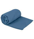 A neatly rolled sea to summit drylite towel medium in moonlight blue with smooth texture and microfiber material