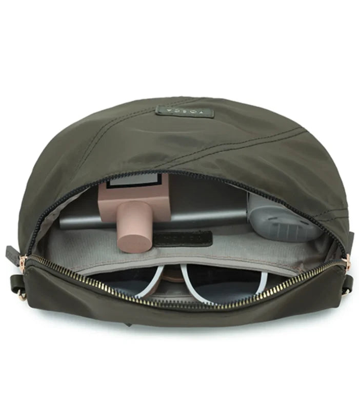 Olive green nylon tosco harlow sling bag with khaki stitch features zippered compartments holding sunglasses and gadgets